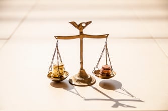 coins-on-brass-weight-scales-2021-08-29-00-54-04-utc